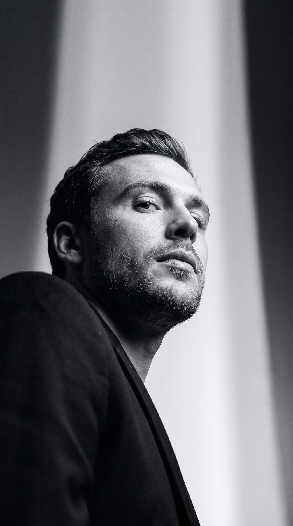 Black-and-white low-angle portrait of a bearded man in dramatic monochrome style, generated with an AI Prompt for ChatGPT and Gemini.