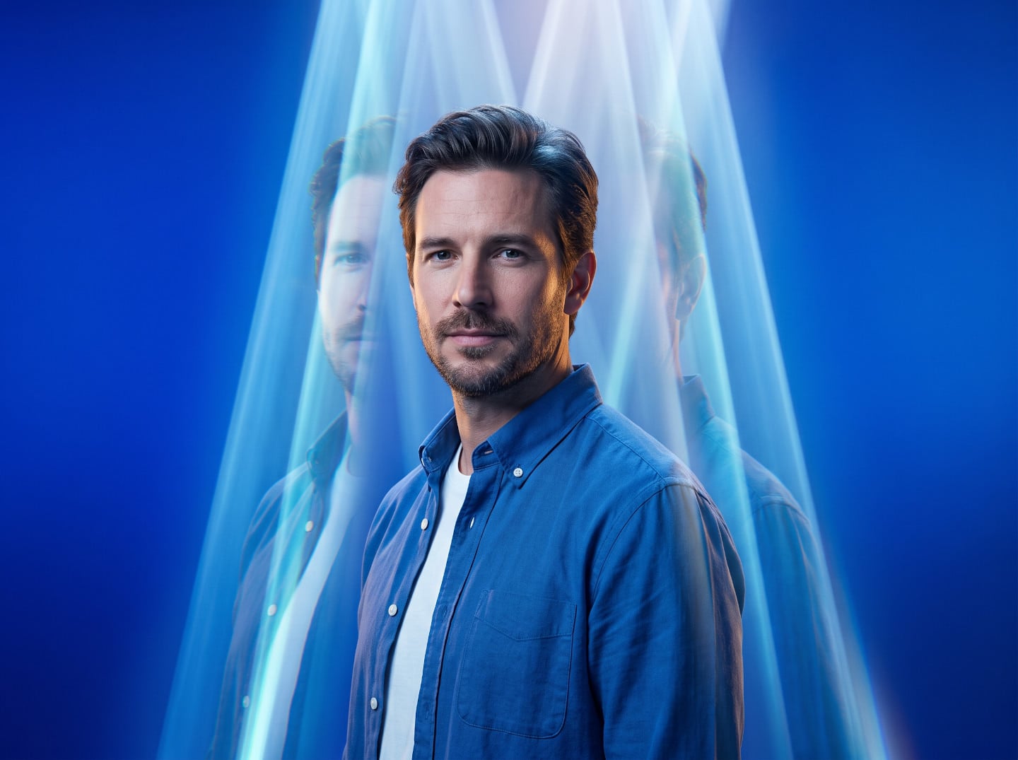 Man in blue shirt posed under atmospheric light with reflected portraits, created with an AI Prompt for ChatGPT and Gemini.